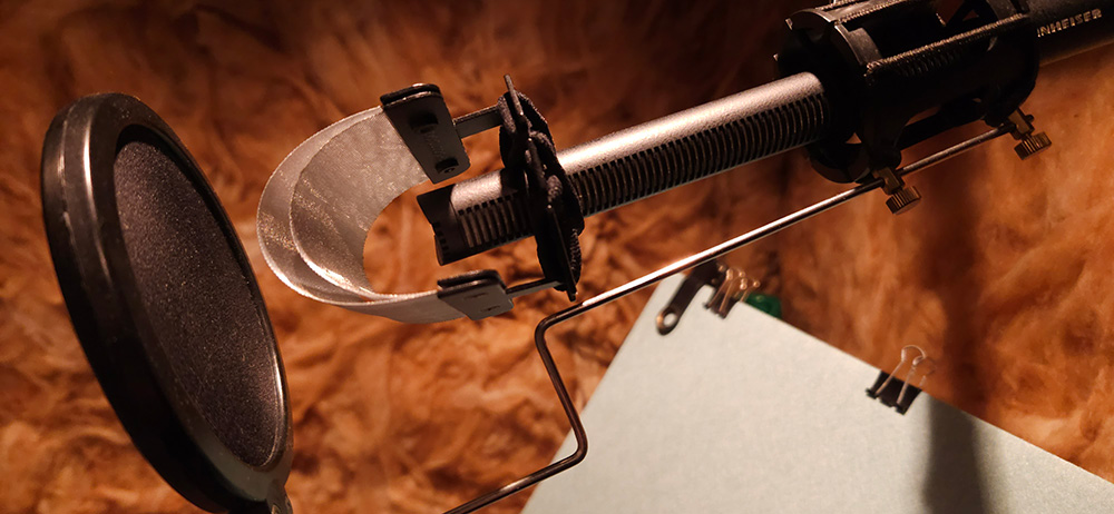 Close-up of the broadcast microphone and pop filter inside the YES AUDIO booth — Caulfield South, Melbourne